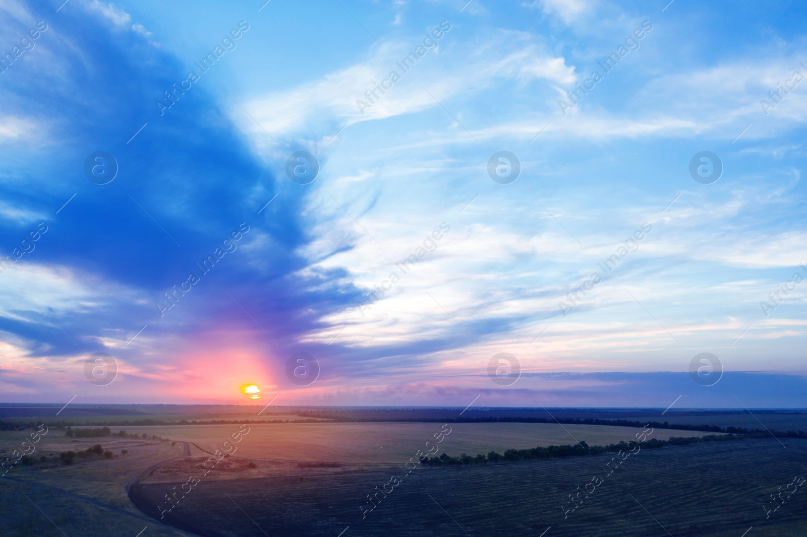 Image of Amazing cloudy sky over fields, aerial view. Sunset landscape