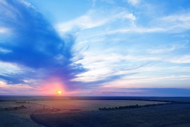 Amazing cloudy sky over fields, aerial view. Sunset landscape