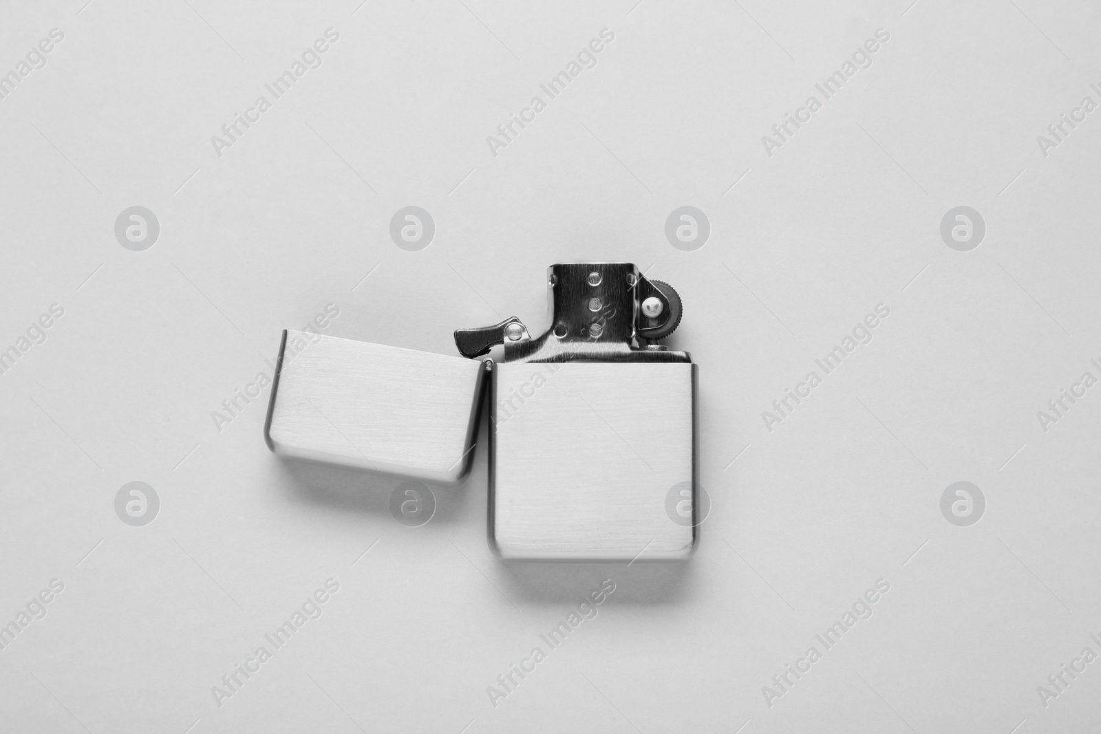 Photo of Gray metallic cigarette lighter on white background, top view