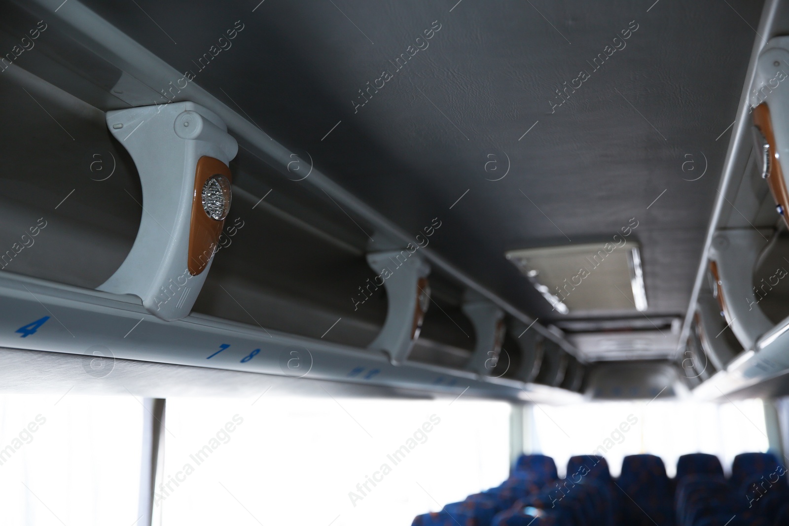 Photo of View of bus interior with shelves for luggage