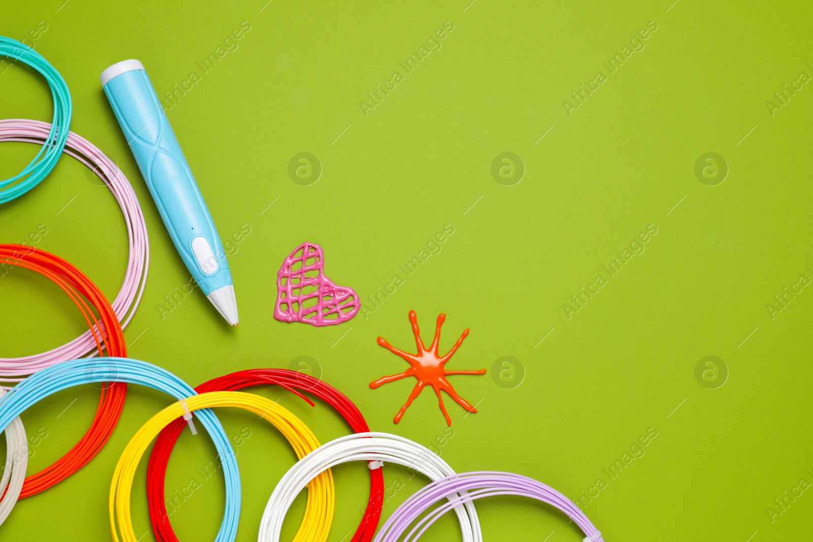 Photo of Stylish 3D pen, colorful plastic filaments and different figures on light green background, flat lay. Space for text