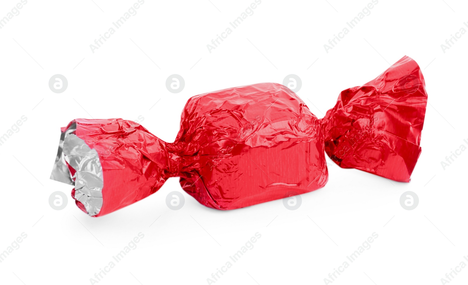 Photo of Tasty candy in red wrapper isolated on white