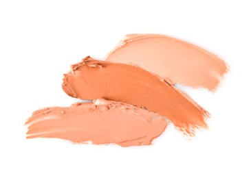 Different shades of foundation on white background. Professional makeup products