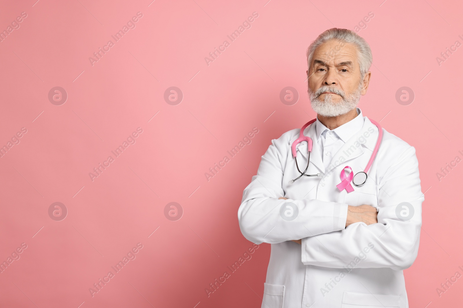 Photo of Mammologist with pink ribbon on color background, space for text. Breast cancer awareness