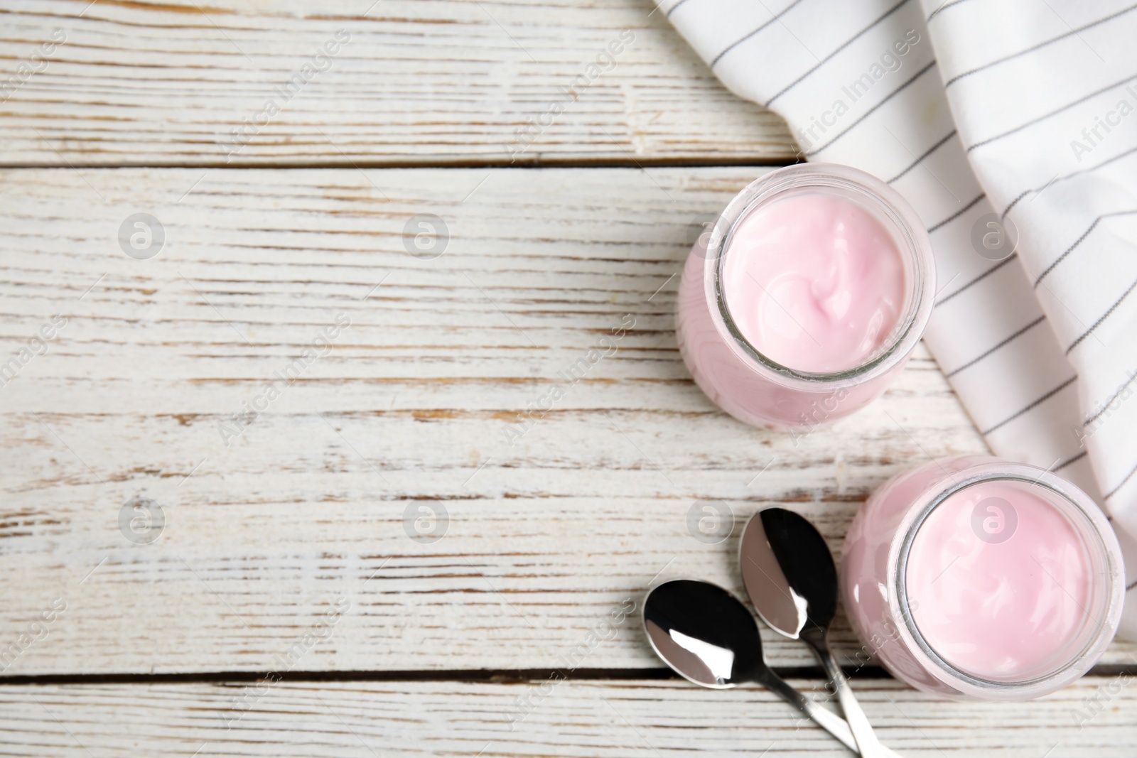 Photo of Flat lay composition with creamy yogurt and space for text on white wooden background