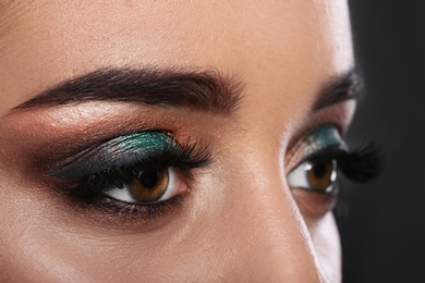 Photo of Young woman with eyelash extensions and beautiful makeup, closeup