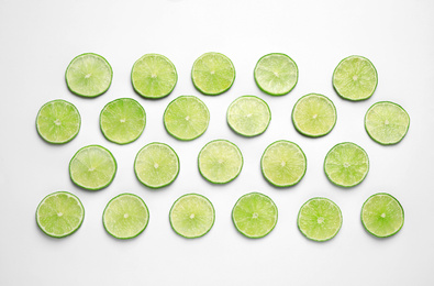 Photo of Juicy fresh lime slices on white background, top view