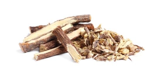 Photo of Dried sticks of liquorice root and shavings on white background