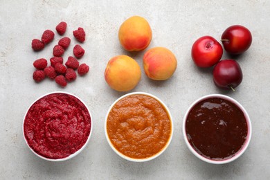 Photo of Different puree in bowls and fresh fruits on light grey table, flat lay