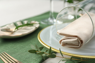 Stylish tableware with leaves on table. Festive setting