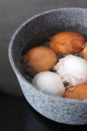 Photo of Chicken eggs boiling in saucepan on electric stove, closeup