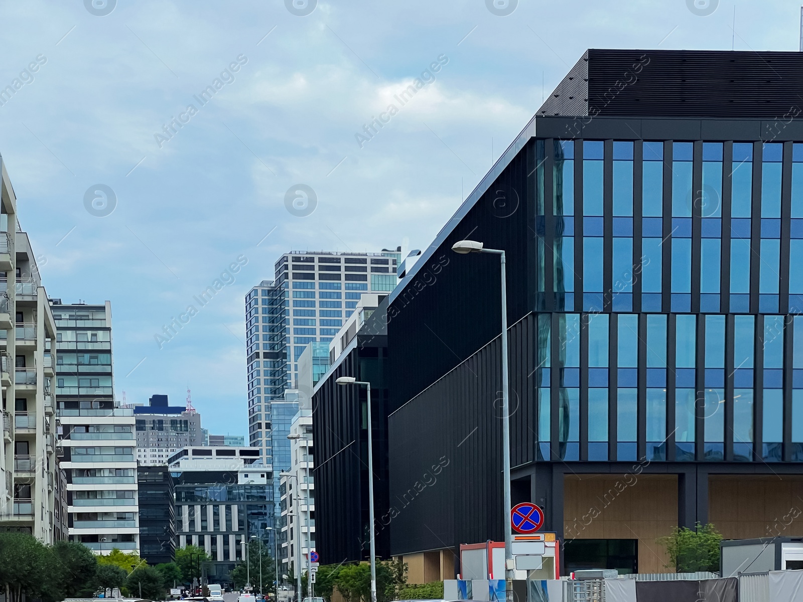 Photo of City street with beautiful buildings under cloudy sky