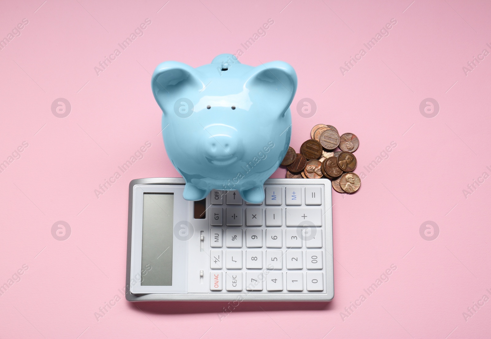 Photo of Calculator, coins and piggy bank on pink background, flat lay