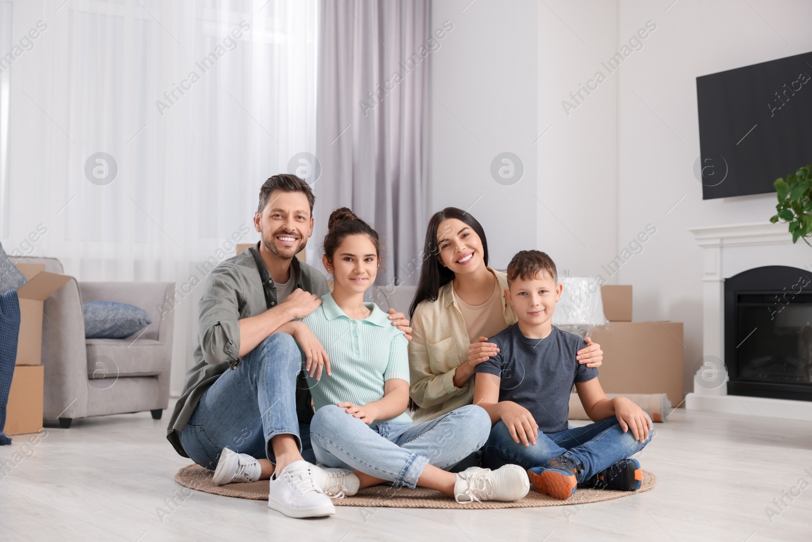 Photo of Happy family spending time in new apartment. Moving day