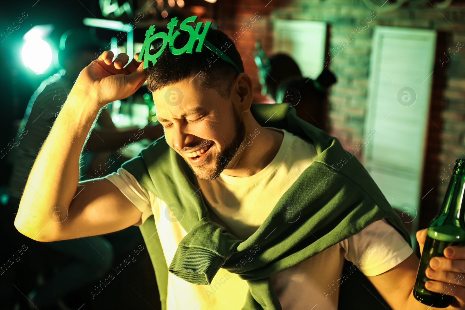 Photo of Man with beer celebrating St Patrick's day in pub