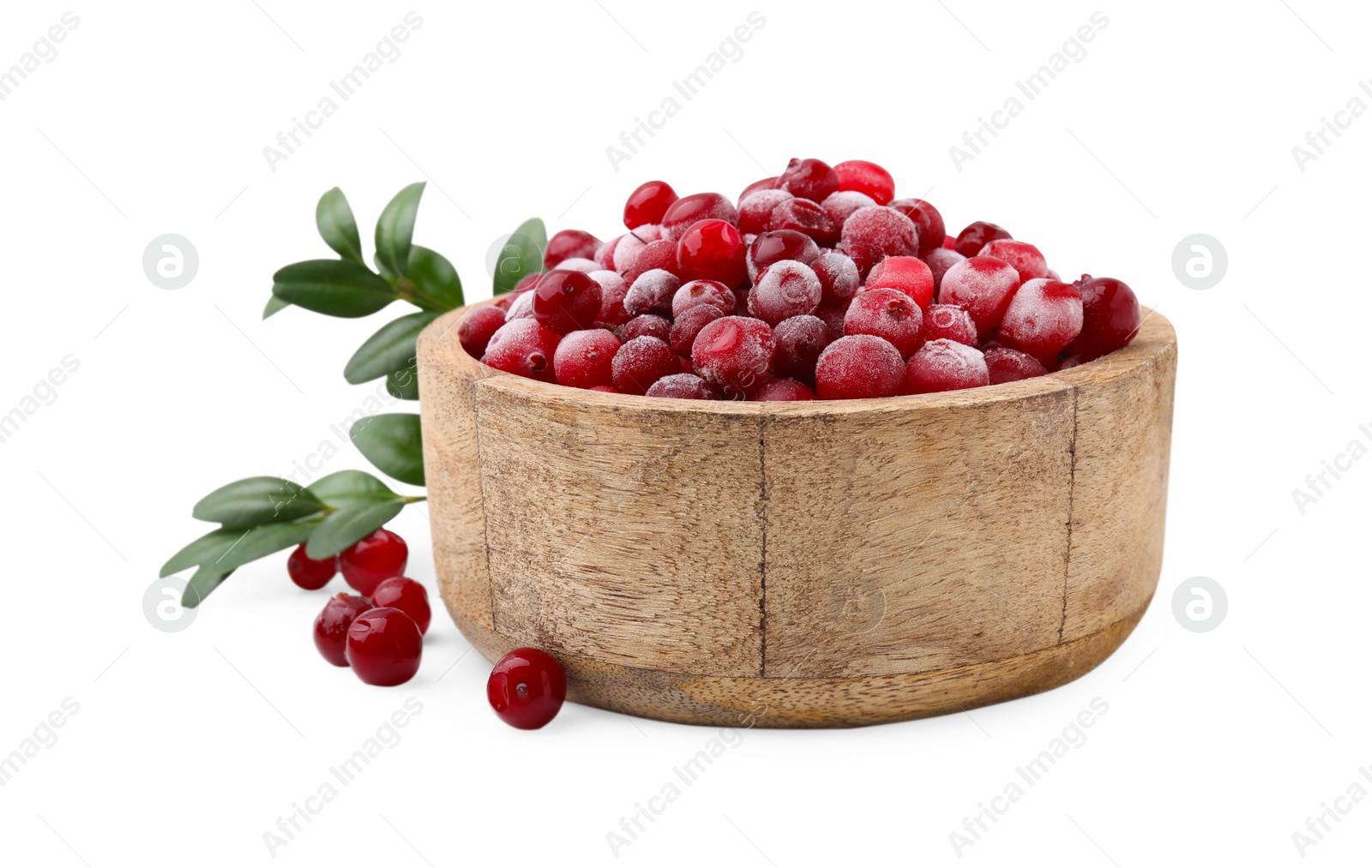 Photo of Frozen red cranberries in bowl and green leaves isolated on white