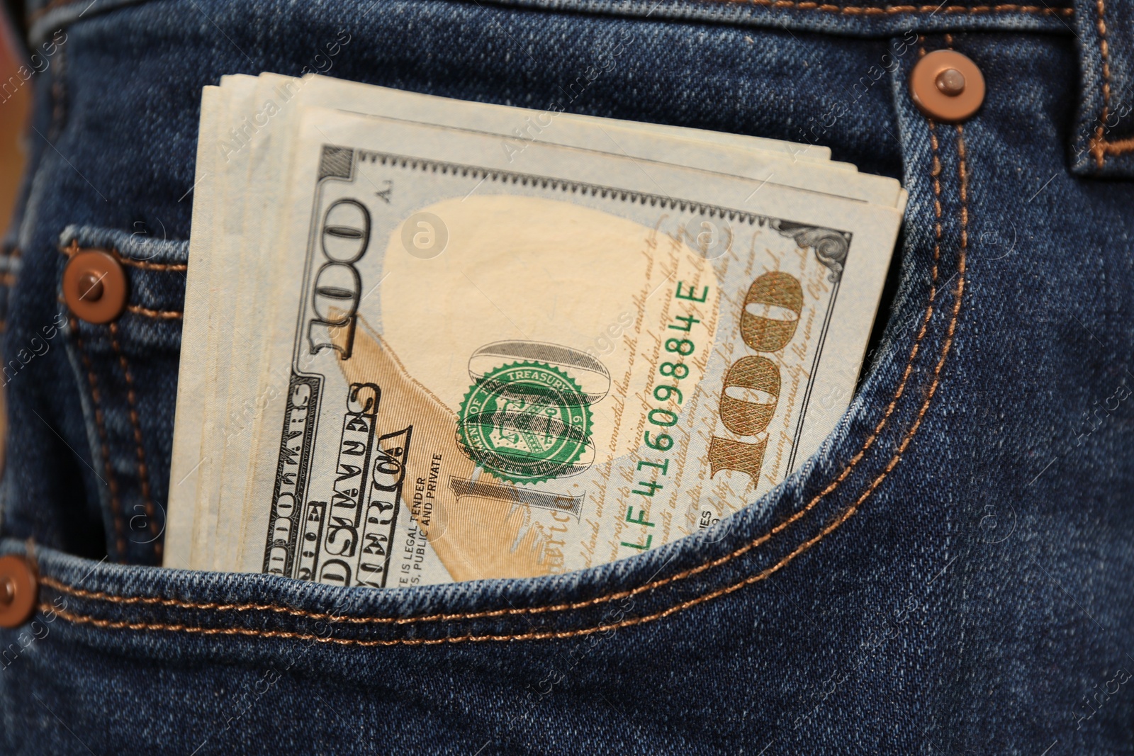 Photo of Dollar banknotes in pocket of jeans, closeup. Spending money