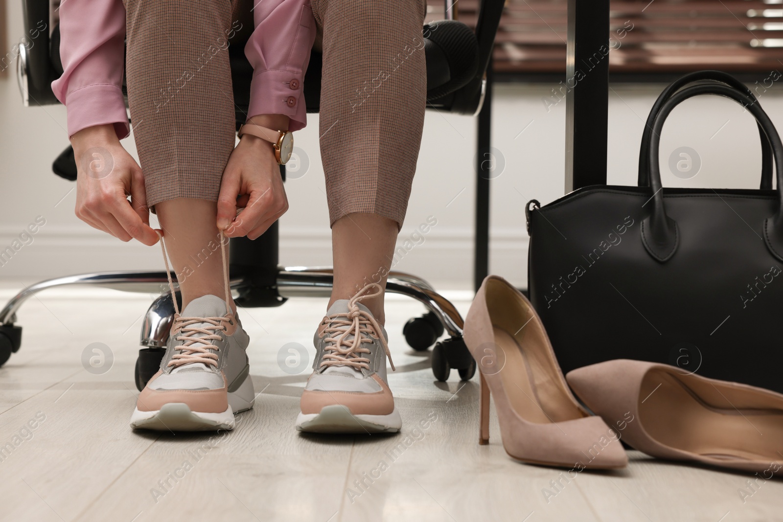 Photo of Woman changing shoes at workplace in office, closeup