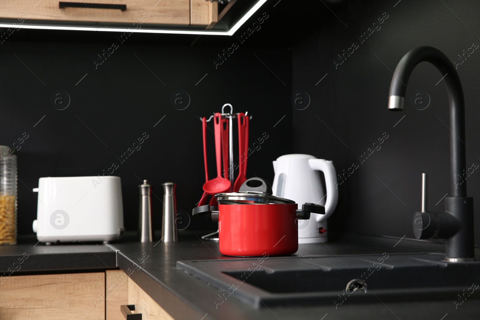 Photo of Stylish kitchen counter with houseware and appliances