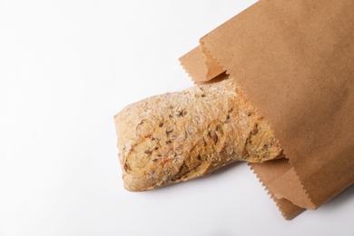 Photo of Paper bag with bread on white background, top view