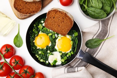 Photo of Flat lay composition with tasty green Shakshouka and ingredients on white table