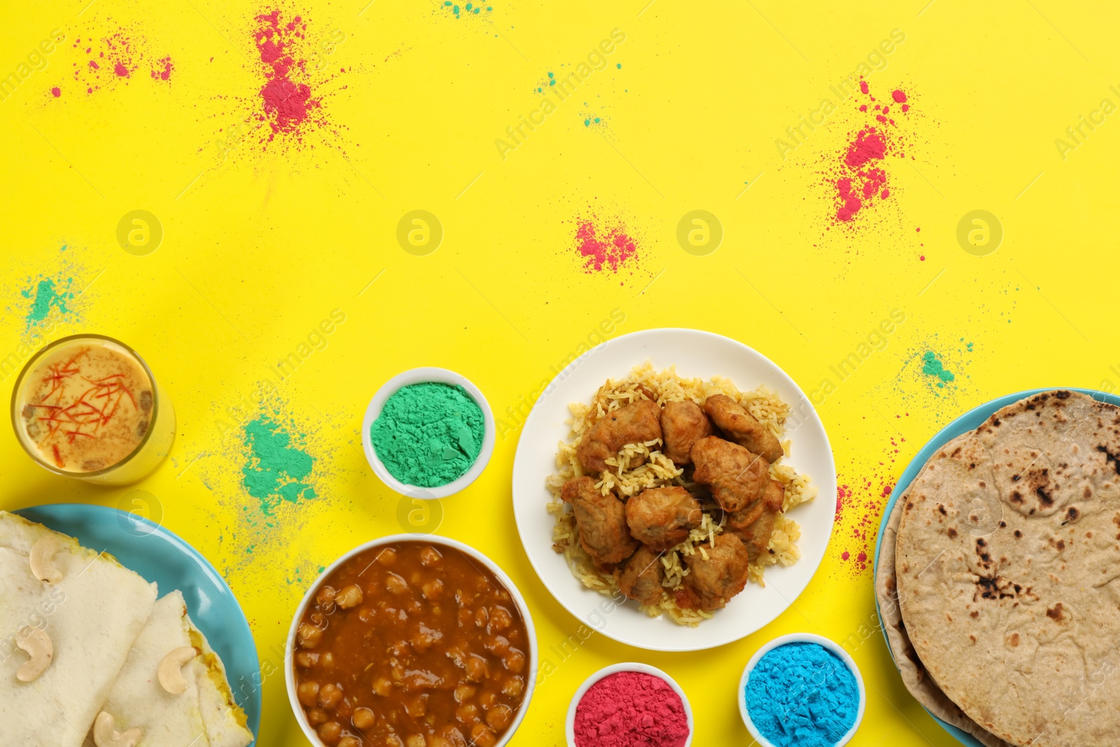 Photo of Traditional Indian food and color powders on yellow background, flat lay. Holi festival celebration