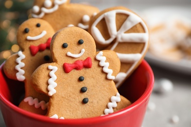 Tasty homemade Christmas cookies in cup on grey table, closeup view