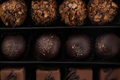 Many different chocolate candies in box, closeup