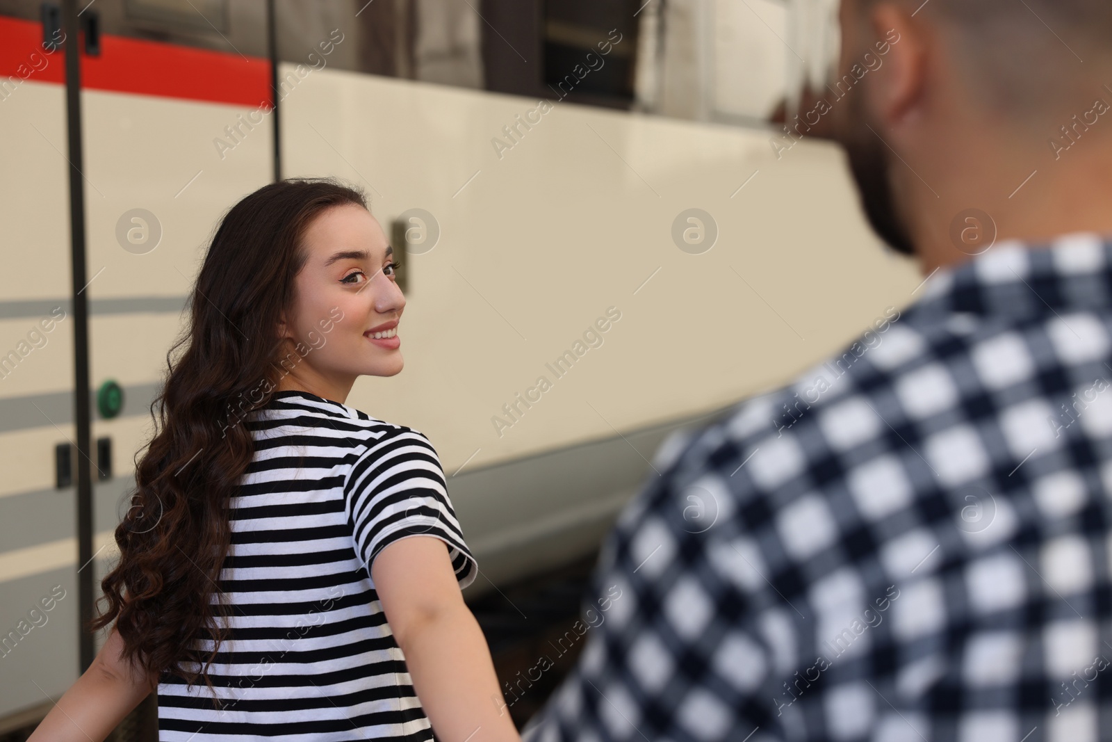 Photo of Long-distance relationship. Couple walking on platform of railway station