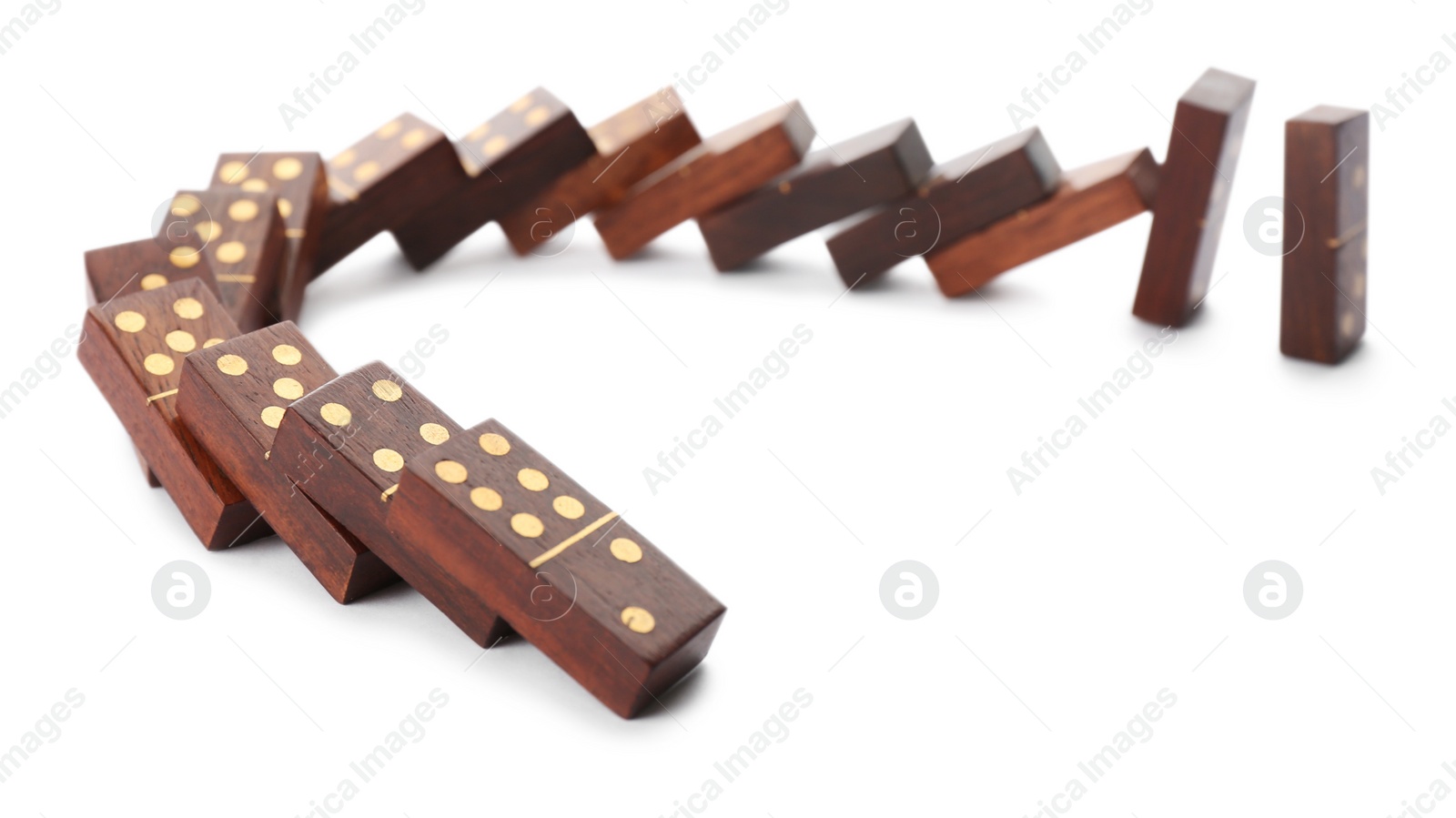 Photo of Wooden domino tiles falling on white background