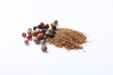 Photo of Aromatic spices. Pile of different ground and whole peppers on white background