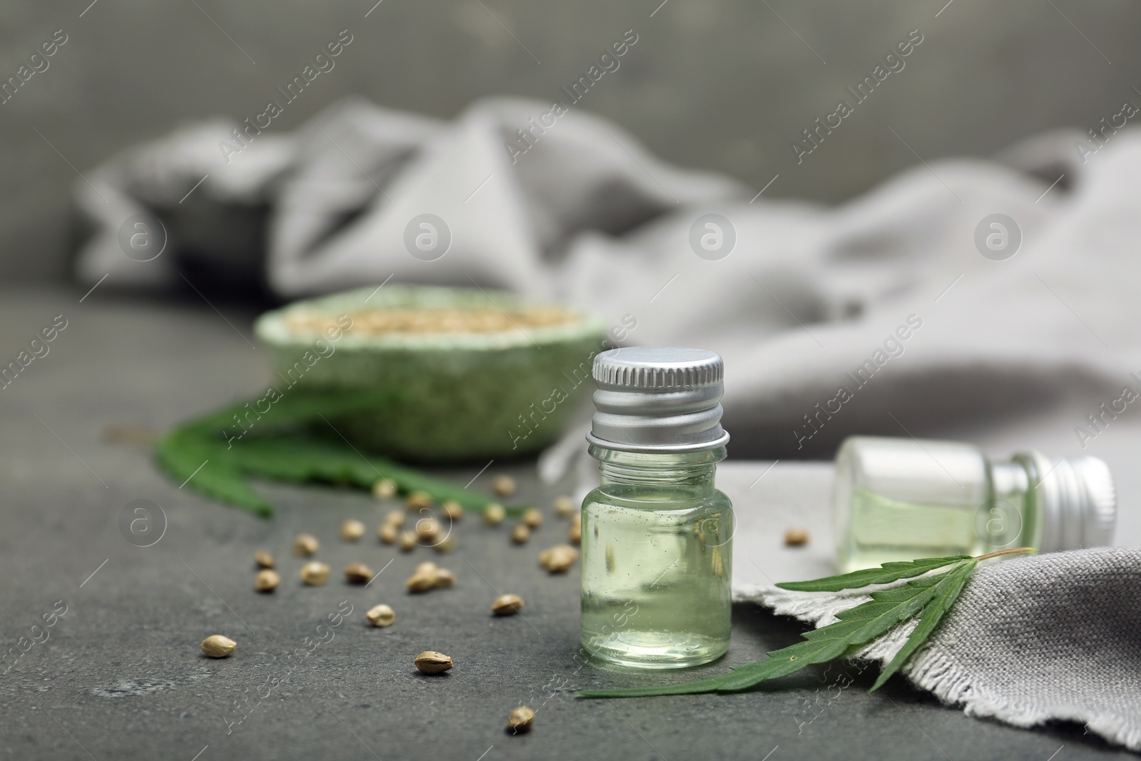 Photo of Bottles of hemp extract on grey table