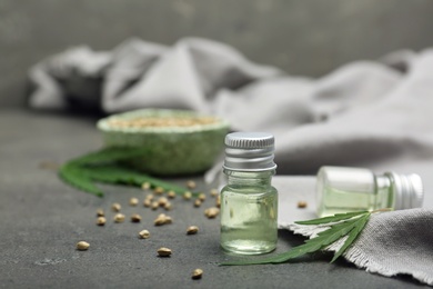 Bottles of hemp extract on grey table