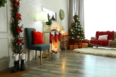 Stylish interior with Christmas tree and decorative fireplace