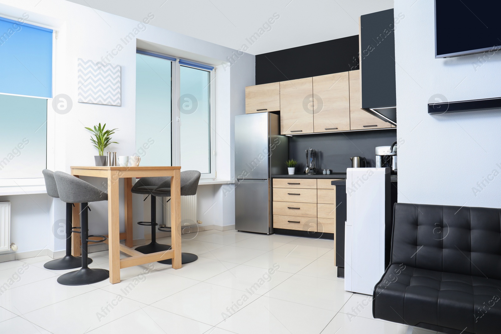 Photo of Cozy modern kitchen interior with new furniture and appliances