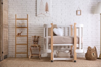 Photo of Baby room interior with toys and stylish furniture