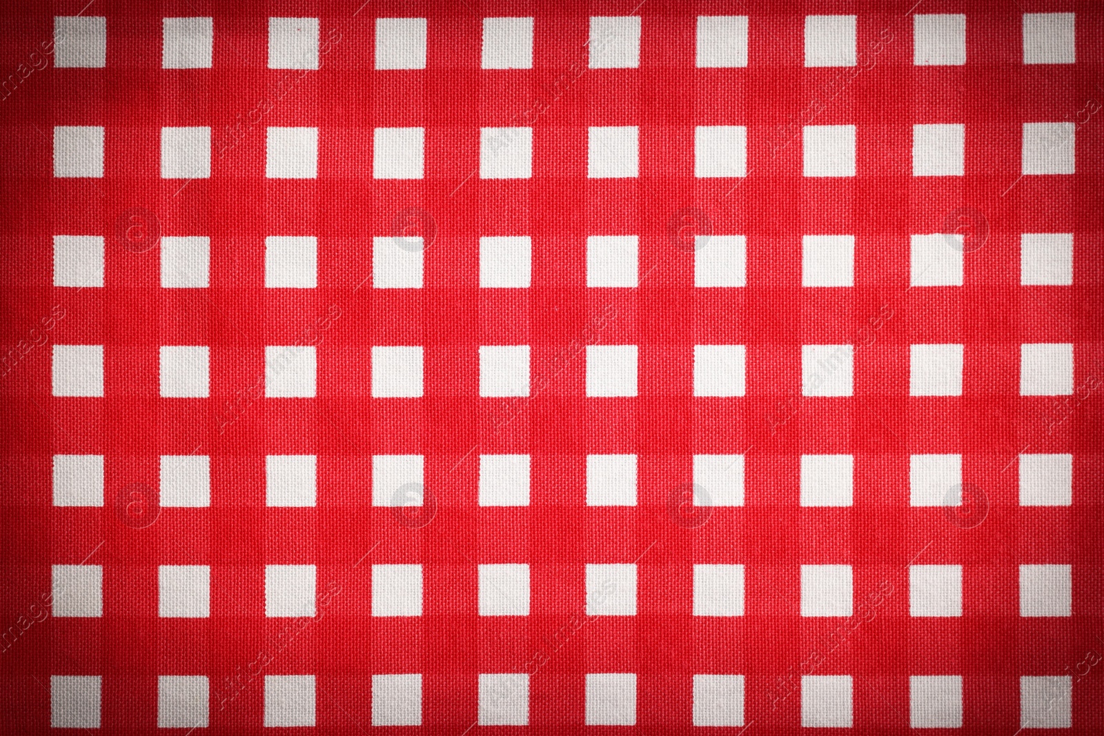 Image of Red and white tablecloth as background, vignette effect