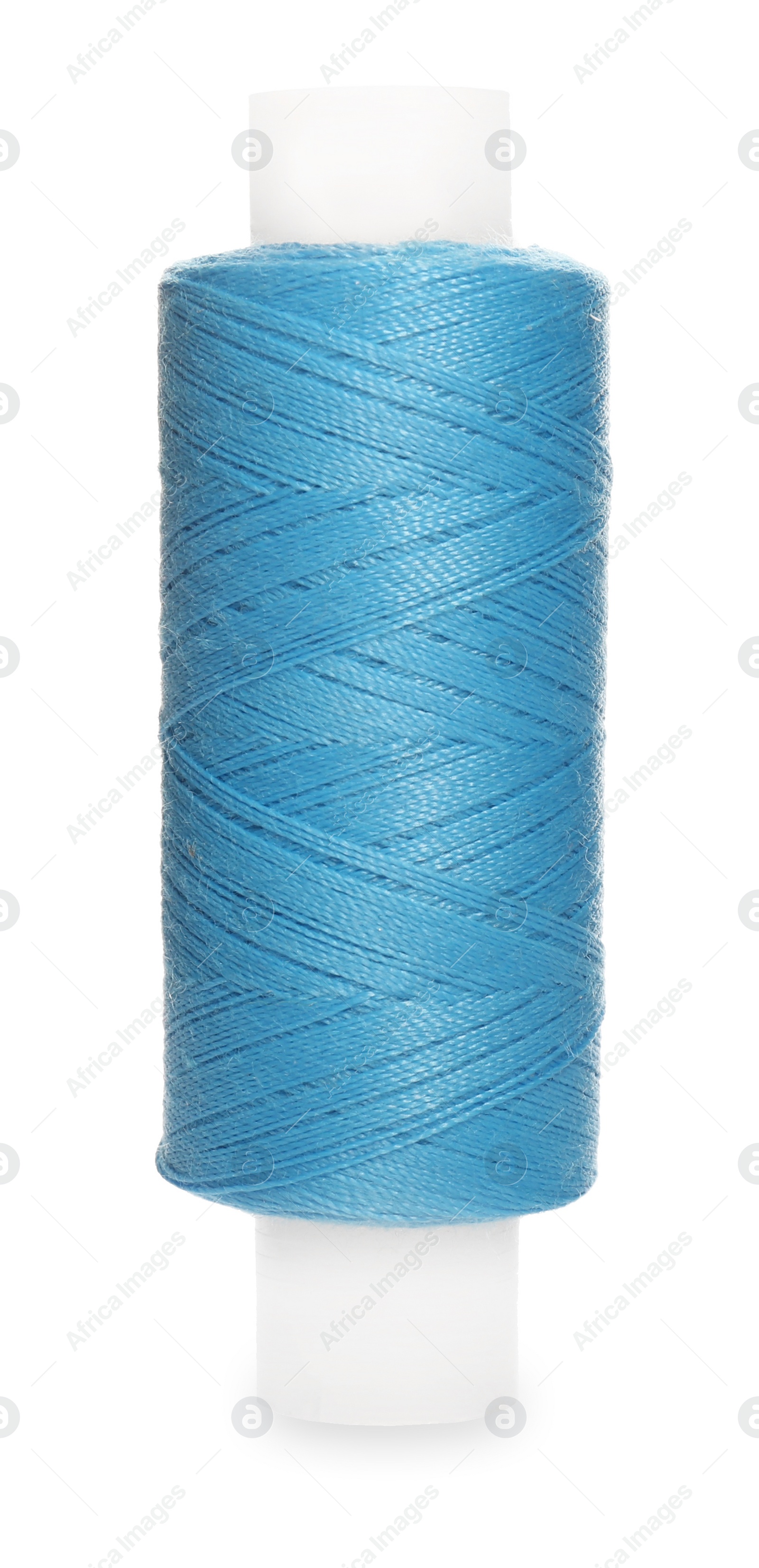 Photo of Spool of light blue sewing thread isolated on white