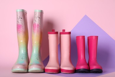 Photo of Three pairs of rubber boots on color background