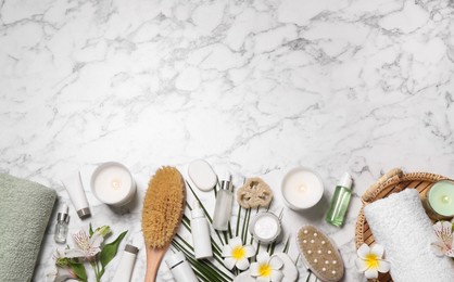 Photo of Flat lay composition with spa essentials on white marble background. Space for text