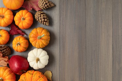 Photo of Thanksgiving day. Flat lay composition with pumpkins on wooden table, space for text