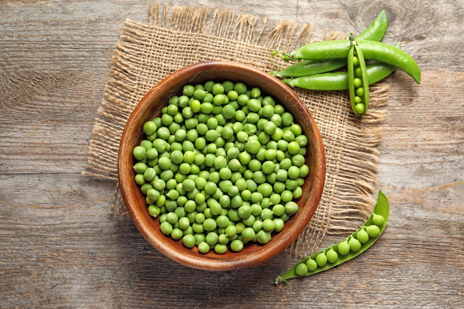 Photo of Flat lay composition with green peas on wooden background