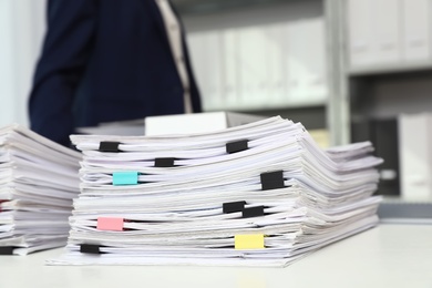 Stack of documents with paper clips on office desk