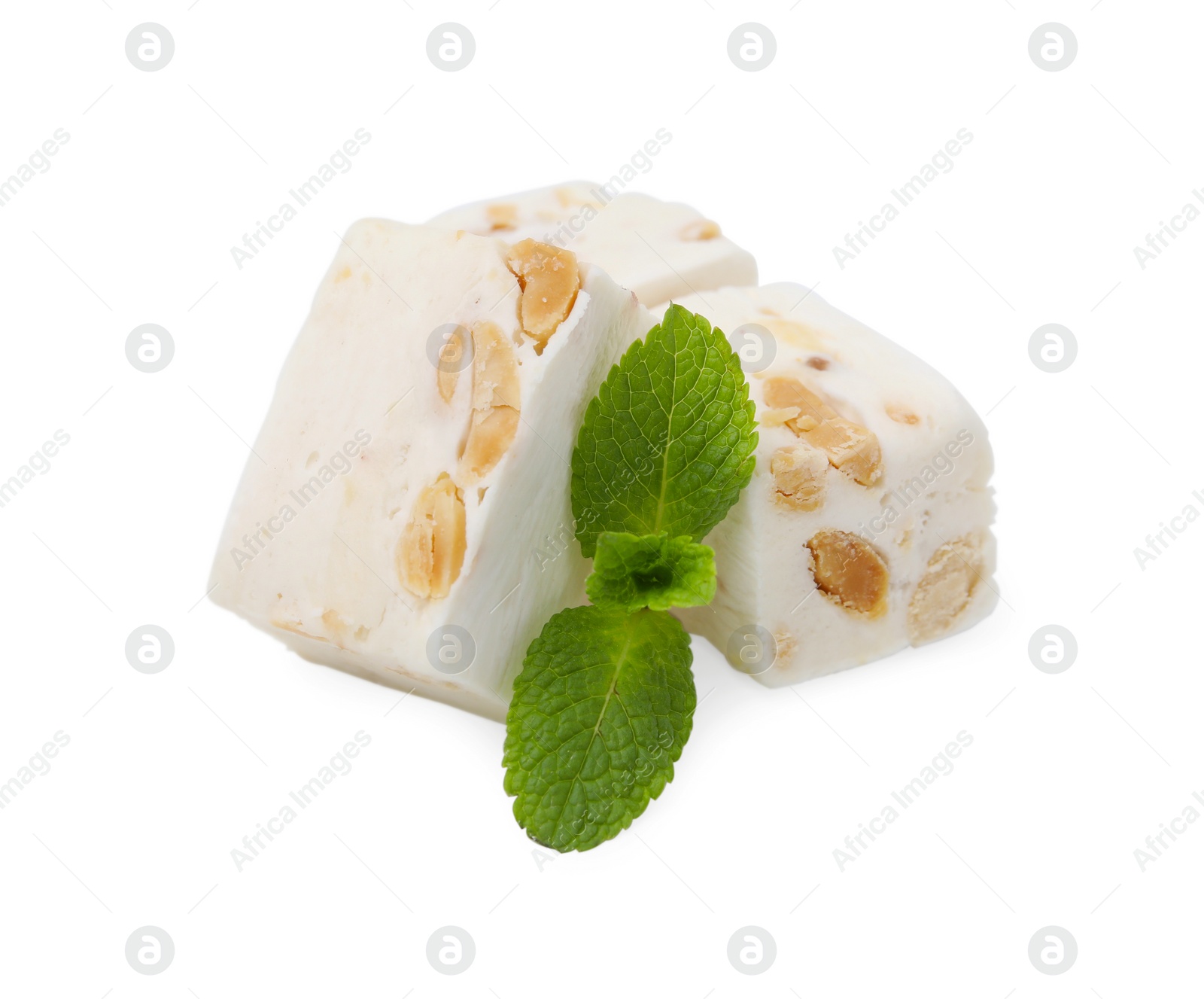 Photo of Pieces of delicious nougat and mint on white background