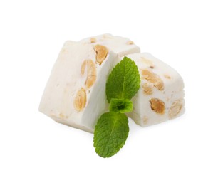 Photo of Pieces of delicious nougat and mint on white background