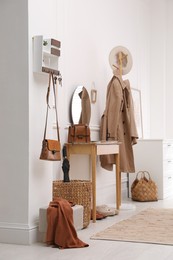 Photo of Modern hallway interior with stylish dressing table and key holder