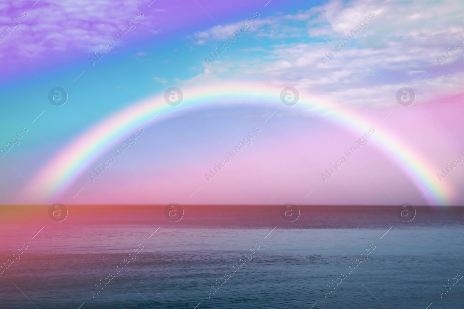 Image of Beautiful view of colorful rainbow in sky over sea