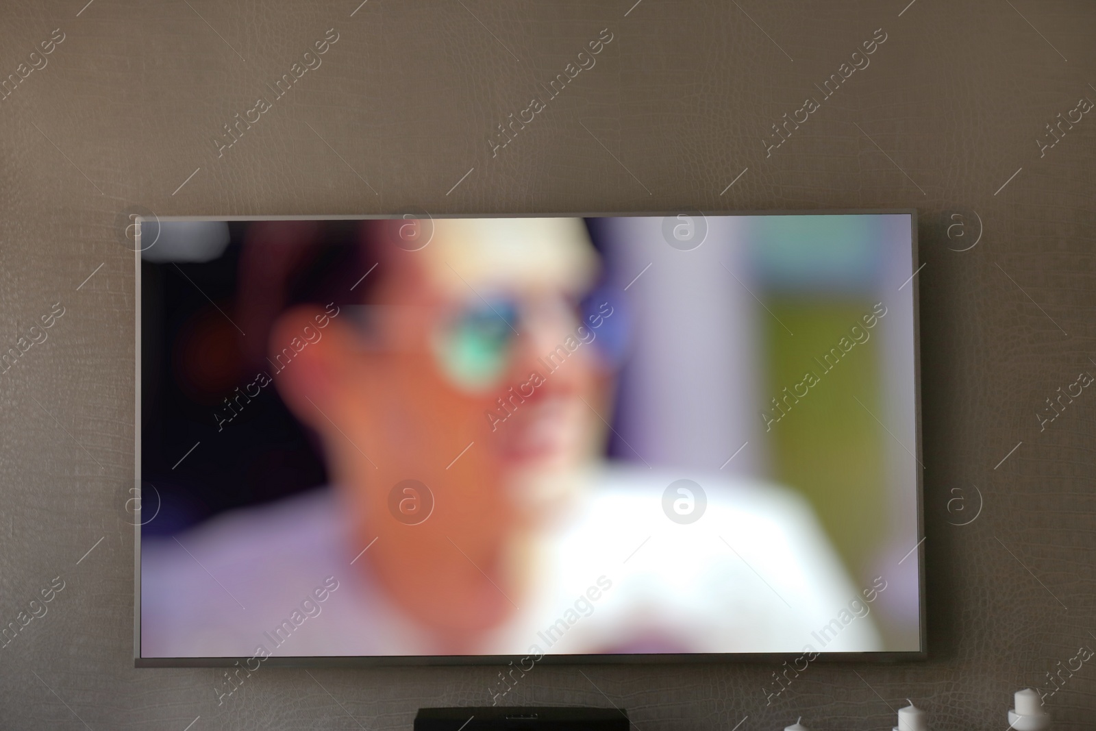 Photo of Large TV screen on grey wall indoors