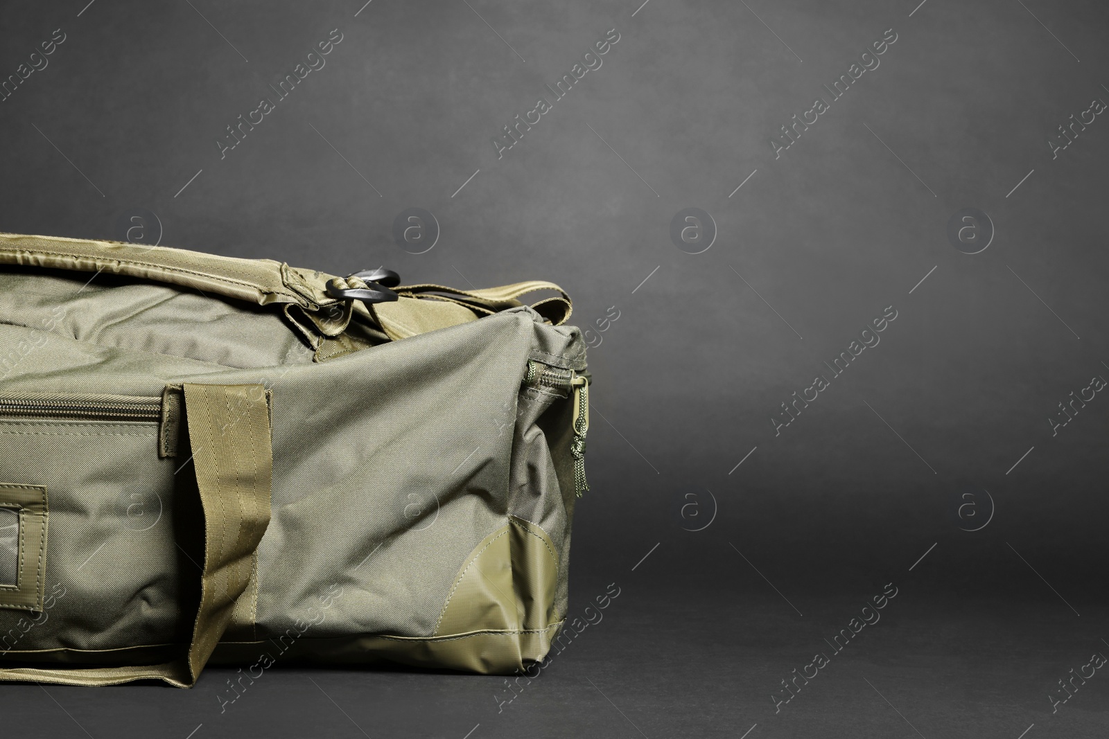 Photo of Army bag on dark grey background, space for text. Military equipment