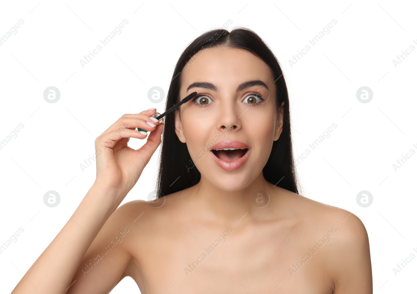 Photo of Beautiful emotional woman applying mascara on white background